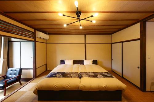 a bedroom with a bed and a ceiling fan at Futari Shizuka in Komagane