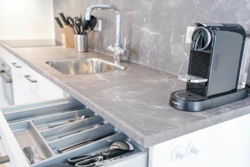 a toaster sitting on a kitchen counter next to a sink at Beautiful Apartment With Loft in Delft