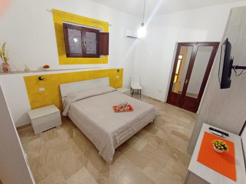 a bedroom with a bed and a television in it at CASA DEL CORSO in Dorgali