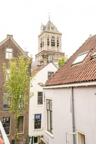 a city with a clock tower in the background at Romantic 35m2 City Center Suite in Delft