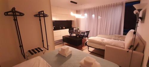 a living room with a couch and a table at Sargaço Suíte Pool and Beach in Póvoa de Varzim