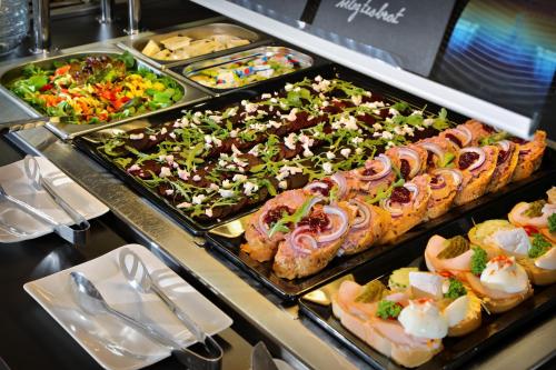 a buffet line with many different types of food at Wellness Hotel Svornost in Harrachov