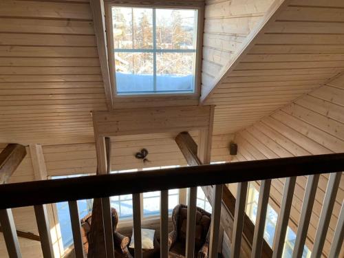 an attic view of a room with a window at VILLA RIIHITONTTU MUURAME RIIHIVUORI in Muurame