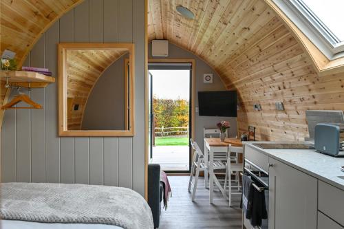 a room with a kitchen and a dining room at Little Quarry Glamping Bed and Breakfast in Tonbridge