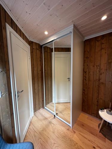 a room with a glass door and wooden walls at Nice apartment on Geilotunet, Close to city center in Geilo