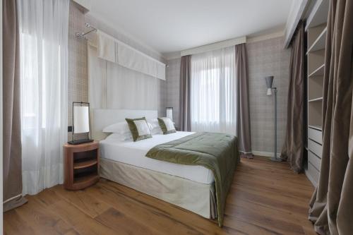 a bedroom with a bed and a television in it at Apartments Florence - Palazzo Signoria luxury Apartments 11-Medusa in Florence