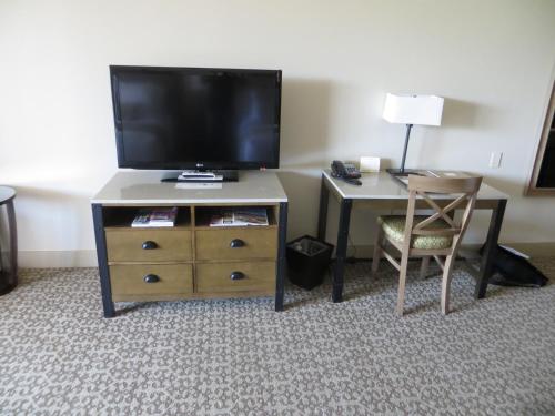 a hotel room with a television and a desk with a chair at Ponte Vineyard Inn in Temecula