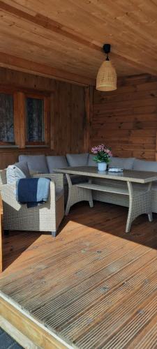 a living room with a couch and a table at Ziedu aleja in Sigulda