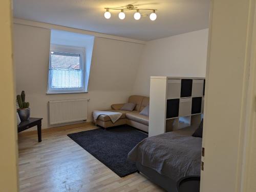 a living room with a bed and a couch at Ferienwohnung am Theater in Schweinfurt