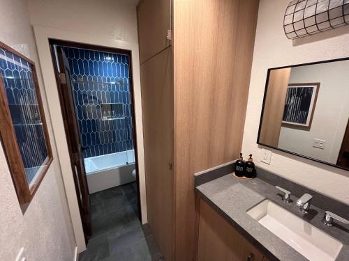 a bathroom with a sink and a mirror at Mammoth Ski & Racquet Club #28, New 2023 Remodel! Walk to Canyon Lodge Lifts in Mammoth Lakes