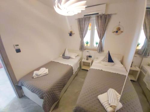 a room with two beds and a mirror at Luxury two-bedroom apartment by the sea U KaLu in Postira