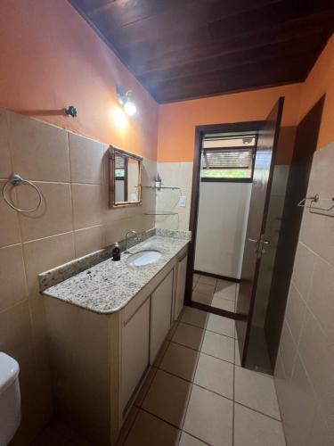 a bathroom with a sink and a toilet at Apartamento Forte in Praia do Forte