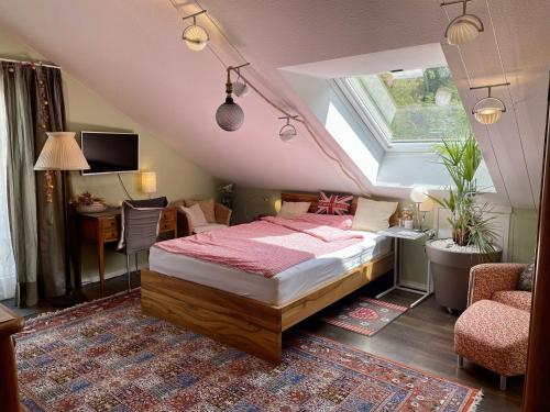 a bedroom with a bed and a desk and a window at Guest Room in Stuttgart-Nord in Stuttgart