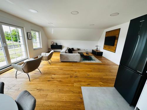 a living room with a couch and a table at Luxeriöse Auszeit im Dreiländereck in Château-Rouge