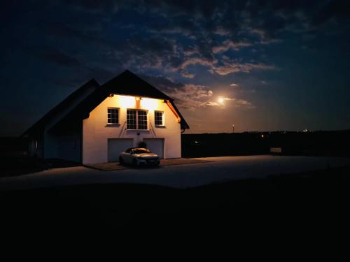 a house with a car parked in front of it at night at Luxeriöse Auszeit im Dreiländereck in Château-Rouge
