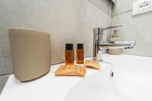 a bathroom sink with two bottles of essential oils on it at Mare Fuori B&B in Pescara
