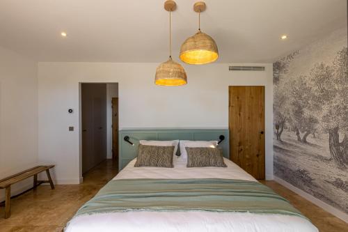 a bedroom with a large bed with two pillows at Le Refuge - Gigaro Lodges in La Croix-Valmer
