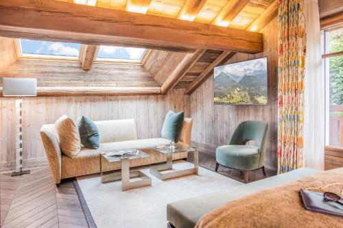 um quarto com um sofá e duas cadeiras e uma mesa em Armancette Hôtel, Chalets & Spa – The Leading Hotels of the World em Saint-Gervais-les-Bains