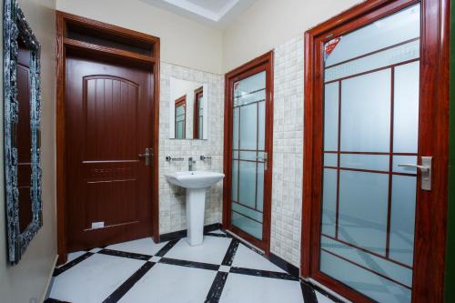 a bathroom with a sink and a mirror at Malaika courts in Kampala