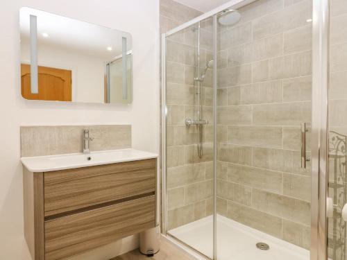 a bathroom with a shower and a sink at Old Cooperage in Port Erroll