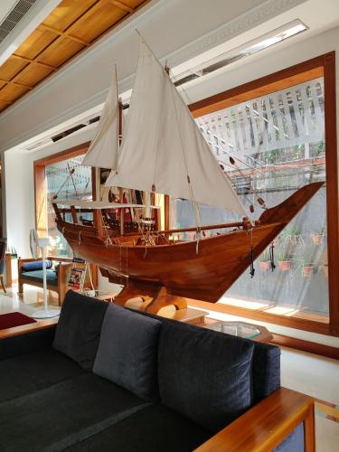 a large wooden boat hanging in a living room at Presidency Kochi City Centre in Cochin