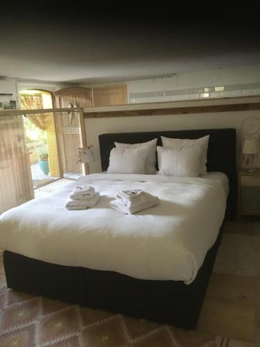 a large bed with two towels on top of it at Studio to rent in Walterswil