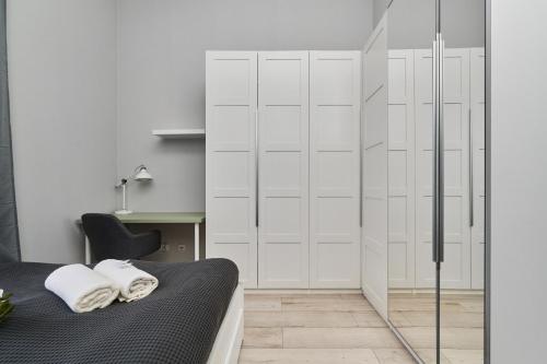 a bedroom with a bed and a glass shower stall at Architektów Avenue Apartment Free Parking by Renters in Wrocław