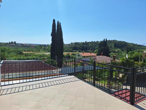 a balcony with a metal railing and some seats at Apartment Vignole in Portorož