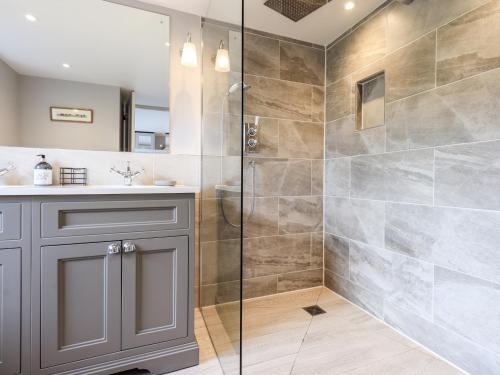a bathroom with a shower and a sink at Fair Rigg in Sawrey