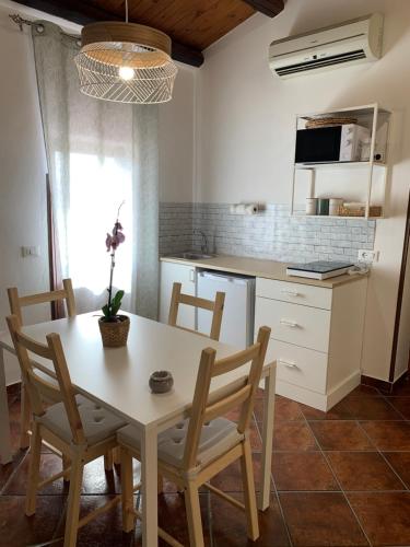 a kitchen with a table and chairs in a kitchen at La mansarda di nonno Calogero in Montelepre