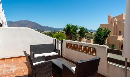 a balcony with chairs and a table on a roof at Estrella de Bahia Casares in Casares