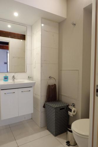 a bathroom with a sink and a toilet and a mirror at SPQR Studios Valletta in Valletta