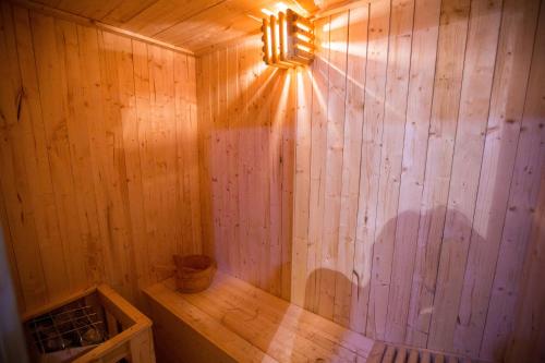 a wooden sauna with a light on the wall at Blue Pine Resort in Lansdowne