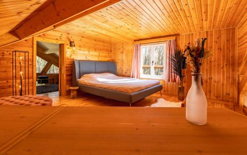 um quarto com uma cama num chalé de madeira em Chalet de Saint Lambert em Amay
