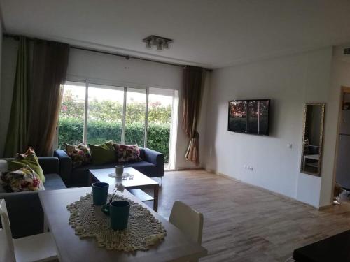 a living room with a couch and a table at Hébergement bord de mer in Casablanca