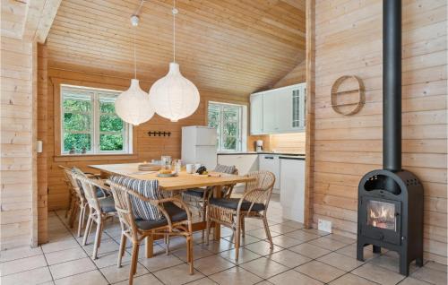 a kitchen and dining room with a wood stove at Beautiful Home In Kalundborg With Sauna in Kalundborg