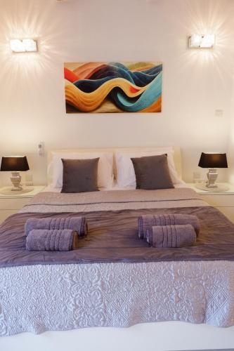a bedroom with a large bed with two lamps at SPQR Studios 2 Valletta in Valletta