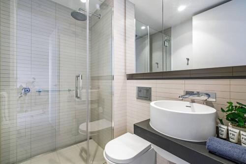 a bathroom with a sink and a toilet and a shower at Premium Albert Park Grand Prix Apartment by Ready Set Host in Melbourne