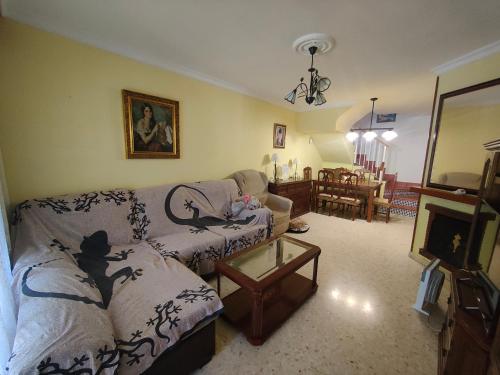 a living room with a couch and a table at Chalet Chilches Costa 1ª linea PLAYA in Vélez-Málaga