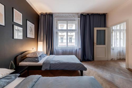 プラハにあるVita Nejedleho apartmentsのベッドルーム1室(ベッド2台、窓付)