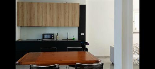 a kitchen with a wooden table and a counter at Bella's Country House 