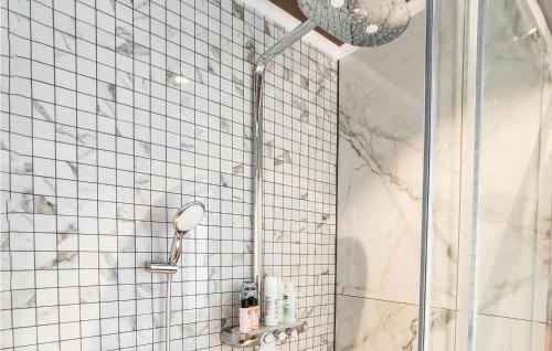 a shower in a bathroom with white tile at Cozy Home In Brevik With House Sea View in Brevik