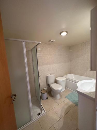 a bathroom with a toilet and a shower and a sink at Relaxing Gateway in Limassol in Episkopi Limassol