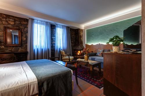 a hotel room with a bed and a couch at Εσπερίδες in Naousa Imathias