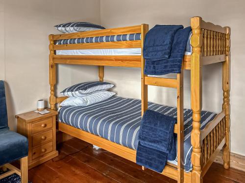 a bunk bed with blue towels on top of it at Selsmore Cottages in South Hayling