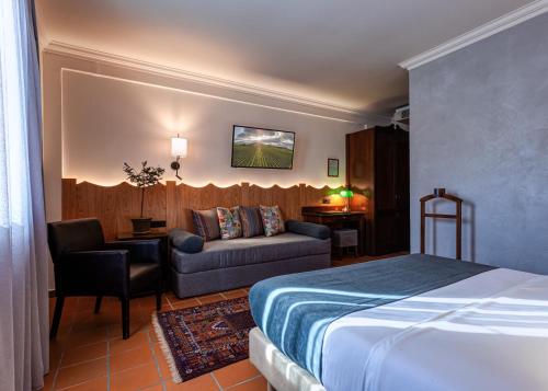 a hotel room with a bed and a couch at Εσπερίδες in Naousa Imathias