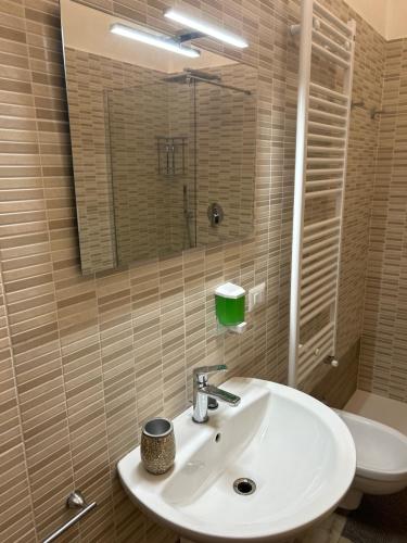 a bathroom with a sink and a toilet and a mirror at Gio' locazione turistica in Conversano