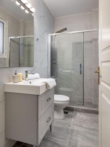 a bathroom with a shower and a sink and a toilet at The Southern Mansion Athens in Athens