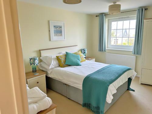 a bedroom with a bed and a window at North Shore in Crantock