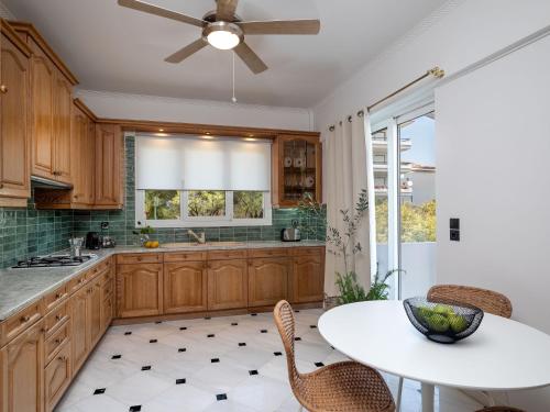 a kitchen with a ceiling fan and a table at The Southern Mansion Athens in Athens